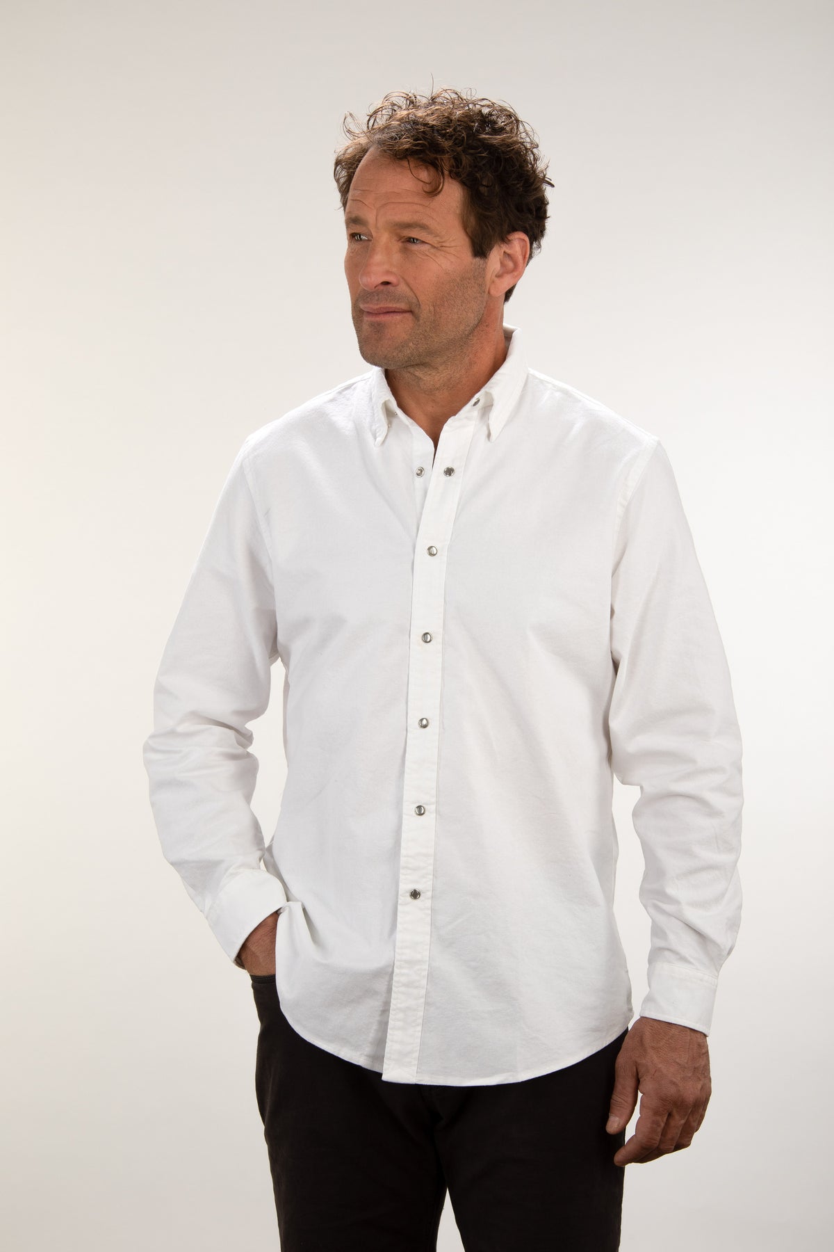 Man wearing the Unbuttoned white oxford snap shirt